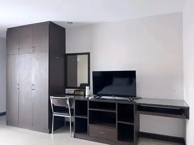 an office with a desk with a television on it at Tongyang House Serviced Apartment in Bangkok
