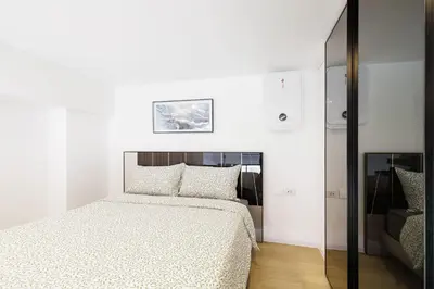 a white bedroom with a bed and a mirror at Loft Pool Superior Suite Near jodd Night Market 500mbps Wi-Fi Twin in Bangkok