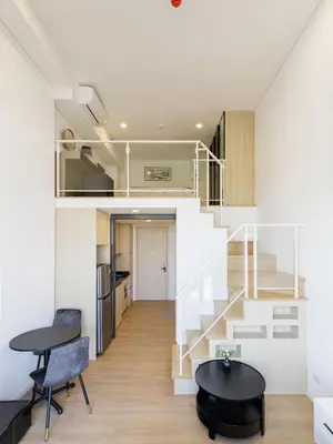 a small apartment with a staircase and a table at Loft Pool Superior Suite Near jodd Night Market 500mbps Wi-Fi Twin in Bangkok