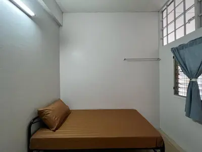 a small room with a bed and a window at Merry V Guesthouse in Bangkok