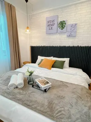a bed with a tray with towels and a book on it at Entire floor,Decorated cozy home, near Grand Palace in Bangkok
