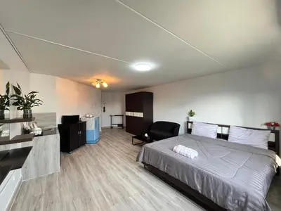 a bedroom with a bed and a desk and a chair at T12 Popular Condo By : hunnity in Ban Bang Phang