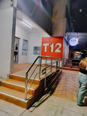 a person standing next to a set of stairs in a store at T12 Popular Condo By : hunnity in Ban Bang Phang