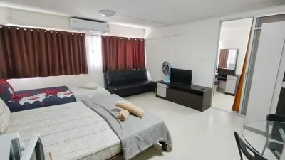 a bedroom with a bed and a couch and a television at Popular The best muangthongthani \u65e5\u5e38\u623f\u95f4\u516c\u5bd3 in Ban Bang Phang