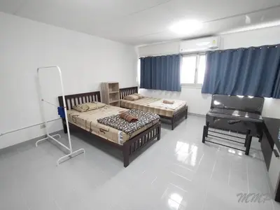 a bedroom with two beds and a piano at Popular The best muangthongthani \u65e5\u5e38\u623f\u95f4\u516c\u5bd3 in Ban Bang Phang