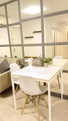 a white dining table and chairs in a room at Elio Del Ray condo feel resort in Bangkok