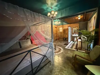 a room with a bed and a chandelier at T-house Bkk - Max15 people with private swimming pool in Bangkok