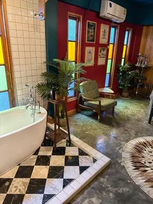 a bathroom with a bath tub and a floor at T-house Bkk - Max15 people with private swimming pool in Bangkok