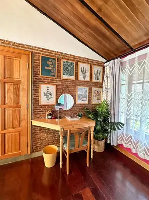 a desk in a room with a brick wall at T-house Bkk - Max15 people with private swimming pool in Bangkok