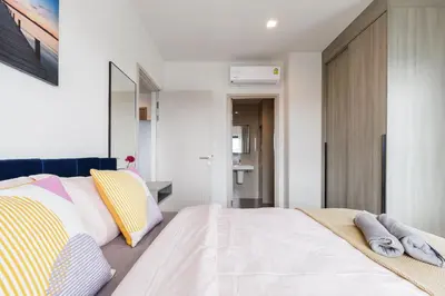 a bedroom with a bed with pillows on it at Bangkok city center-thong lo-rca-high-rise one-bedroom in Bangkok