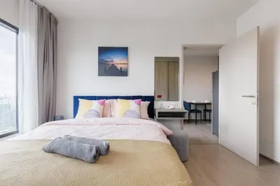 a bedroom with a large bed with a large window at Bangkok city center-thong lo-rca-high-rise one-bedroom in Bangkok