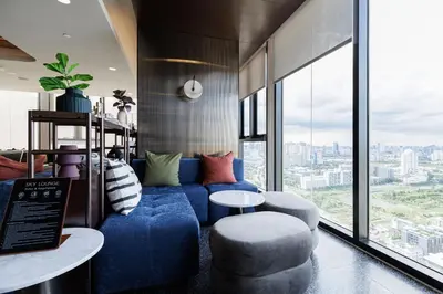 a living room with a blue couch and chairs and windows at 2 bedrooms -1 living room and 1 bathroom - swimming pool in Ban Rang Sai (2)