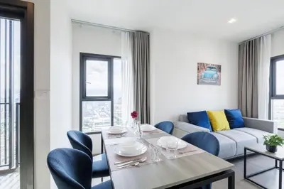 a living room with a table and blue chairs at 2 bedrooms -1 living room and 1 bathroom - swimming pool in Ban Rang Sai (2)
