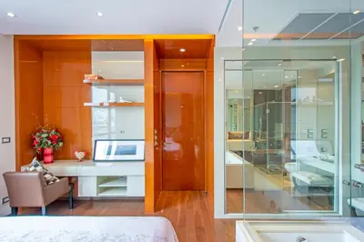 a room with a bed and a desk with a computer at Luxury 1BR 300m BTS PhromPhong, Empo, EmQ, EmSphere, Rooftop Pool, Gym, Fast 500mbps wifi in Bangkok