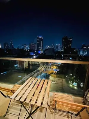 a bench on top of a building with a city skyline at Luxury 1BR 300m BTS PhromPhong, Empo, EmQ, EmSphere, Rooftop Pool, Gym, Fast 500mbps wifi in Bangkok