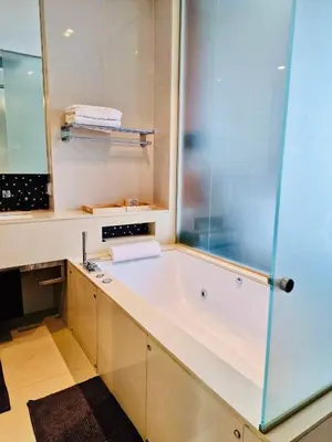 a bathroom with a tub and a sink at Luxury 1BR 300m BTS PhromPhong, Empo, EmQ, EmSphere, Rooftop Pool, Gym, Fast 500mbps wifi in Bangkok
