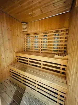 a wooden sauna with a wooden bench in it at Luxury 1BR 300m BTS PhromPhong, Empo, EmQ, EmSphere, Rooftop Pool, Gym, Fast 500mbps wifi in Bangkok