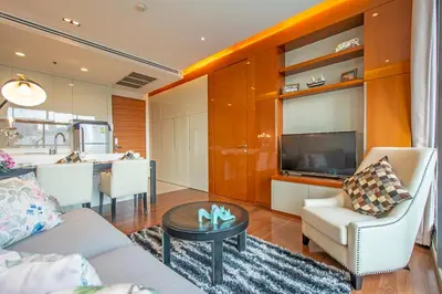 a living room with a couch and a table at Luxury 1BR 300m BTS PhromPhong, Empo, EmQ, EmSphere, Rooftop Pool, Gym, Fast 500mbps wifi in Bangkok