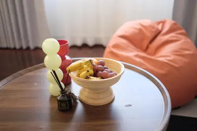 a table with a bowl of fruit on a table at SANT Bangkok at Khaosan Road in Bangkok
