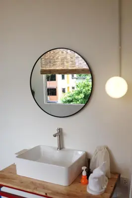 a bathroom with a sink and a mirror on the wall at SANT Bangkok at Khaosan Road in Bangkok