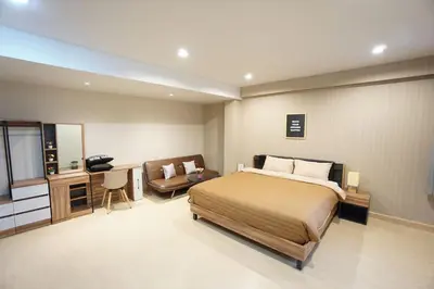 a bedroom with a bed and a desk and a chair at Maruay Living Apartment (Khaosan/Chinatown/Samyot MRT) in Bangkok