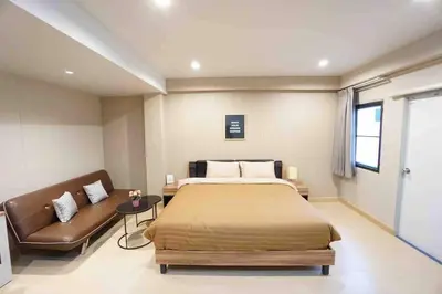 a bedroom with a bed and a couch at Maruay Living Apartment (Khaosan/Chinatown/Samyot MRT) in Bangkok