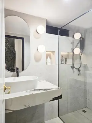 a bathroom with a sink and a shower with a mirror at PB home 1 min to BTS Saladaeng & MRT Silom in Bang Rak