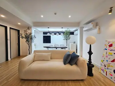 a living room with a couch and a table at PB home 1 min to BTS Saladaeng & MRT Silom in Bang Rak