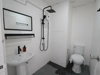 a white bathroom with a toilet and a sink at RoomQuest IT Square Don Mueang Airport in Bangkok