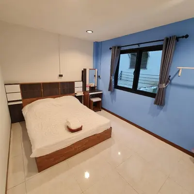 a bedroom with a large bed and a window at Noc House in Bang Khlo