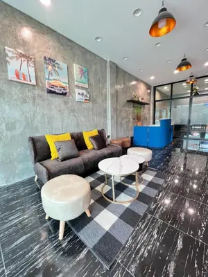 a living room with a couch and tables at Noc House in Bang Khlo