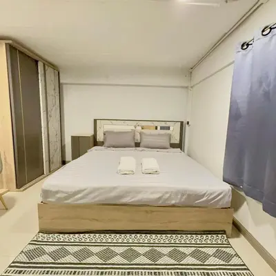 a bedroom with a large bed with two towels on it at Noc House in Bang Khlo