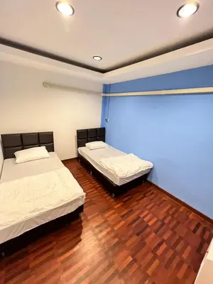 two beds in a room with wooden floors at Noc House in Bang Khlo