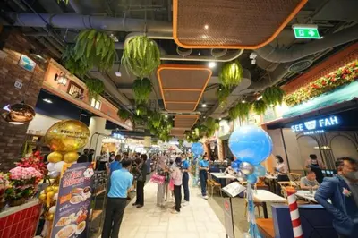 a group of people walking through a shopping mall at Noc House in Bang Khlo