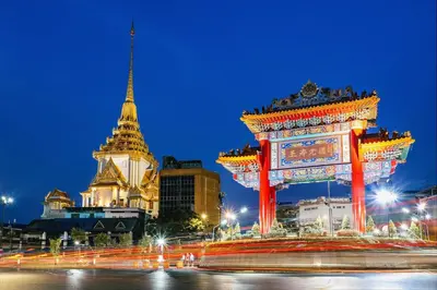 a large gate in front of a building at night at The Character Yaowarat เดอะคาแลตเตอร์ เยาวราช in Khlong San