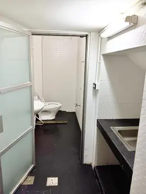 an empty bathroom with a toilet and a sink at The Character Yaowarat เดอะคาแลตเตอร์ เยาวราช in Khlong San