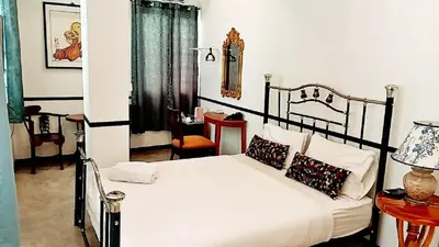 a bedroom with a black and white bed with pillows at The Character Yaowarat เดอะคาแลตเตอร์ เยาวราช in Khlong San