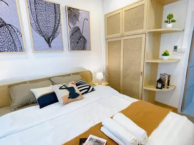 a bedroom with a large white bed with pillows at Relax Private terrace&cozy BR,near Grand palace in Bangkok