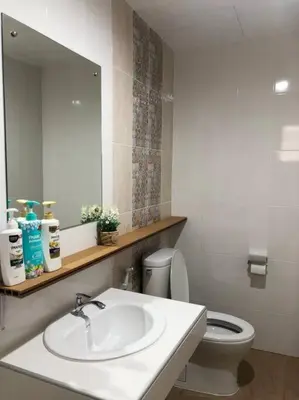 a bathroom with a sink and a toilet and a mirror at Maruay Living Apartment 401 (Khaosan/Chinatown/Samyot MRT) in Bangkok