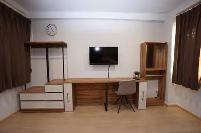 a room with a desk with a tv on a wall at Maruay Living Apartment 510 (Khaosan/Chinatown/Samyot MRT) in Bangkok