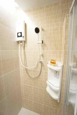 a bathroom with a shower and a toilet in it at Maruay Living Apartment 509 (Khaosan/Chinatown/Samyot MRT) in Bangkok