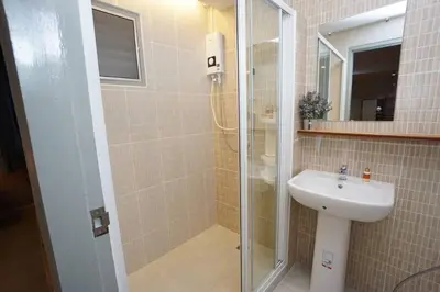 a bathroom with a sink and a glass shower at Maruay Living Apartment 509 (Khaosan/Chinatown/Samyot MRT) in Bangkok