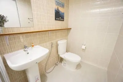 a bathroom with a white toilet and a sink at Maruay Living Apartment 509 (Khaosan/Chinatown/Samyot MRT) in Bangkok