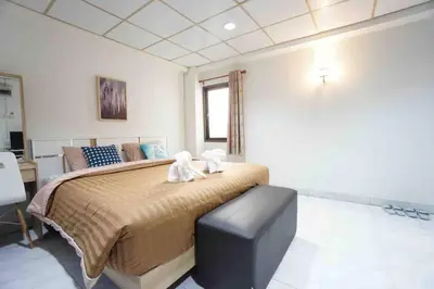 a bedroom with a large bed with two stuffed animals on it at Maruay Living Apartment 506 (Khaosan/Chinatown/Samyot MRT) in Bangkok