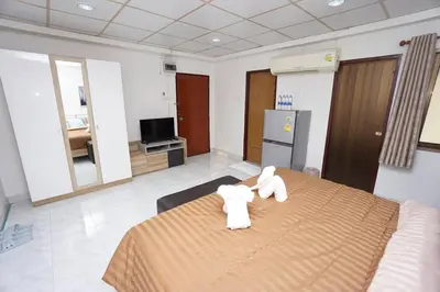 a room with a bed with two white towels on it at Maruay Living Apartment 506 (Khaosan/Chinatown/Samyot MRT) in Bangkok