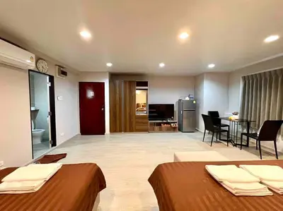 a room with two beds and a living room at Maruay Living Apartment 501 (Khaosan/Chinatown/Samyot MRT) in Bangkok