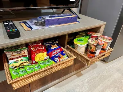 a counter with two baskets of food on a table at Maruay Living Apartment 501 (Khaosan/Chinatown/Samyot MRT) in Bangkok