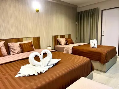 a hotel room with two beds with white swans on them at Maruay Living Apartment 501 (Khaosan/Chinatown/Samyot MRT) in Bangkok