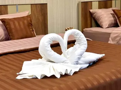two white swans sitting on top of a bed at Maruay Living Apartment 501 (Khaosan/Chinatown/Samyot MRT) in Bangkok