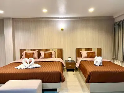 two beds in a hotel room with towels on them at Maruay Living Apartment 501 (Khaosan/Chinatown/Samyot MRT) in Bangkok